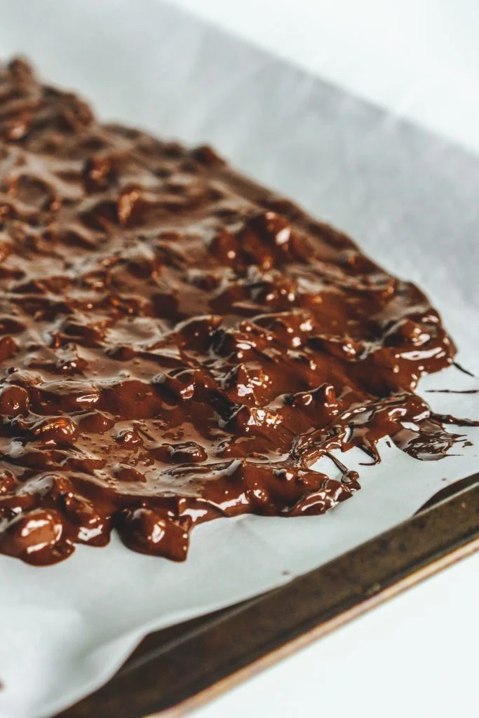 chocolate and almonds spread on parchment paper