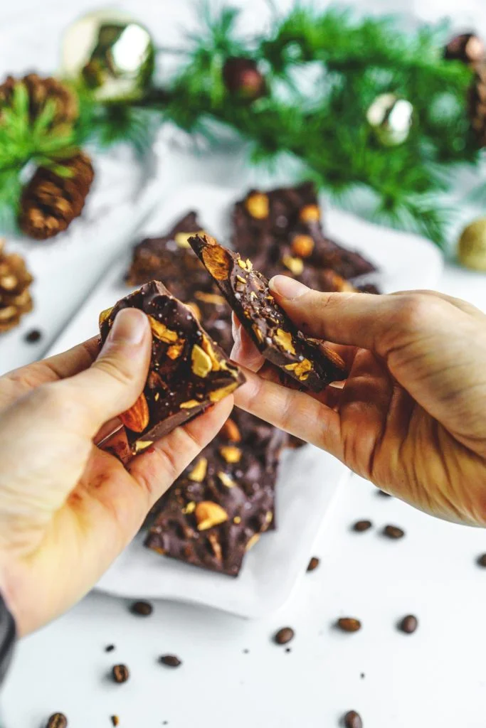 hands breaking chocolate coffee bark