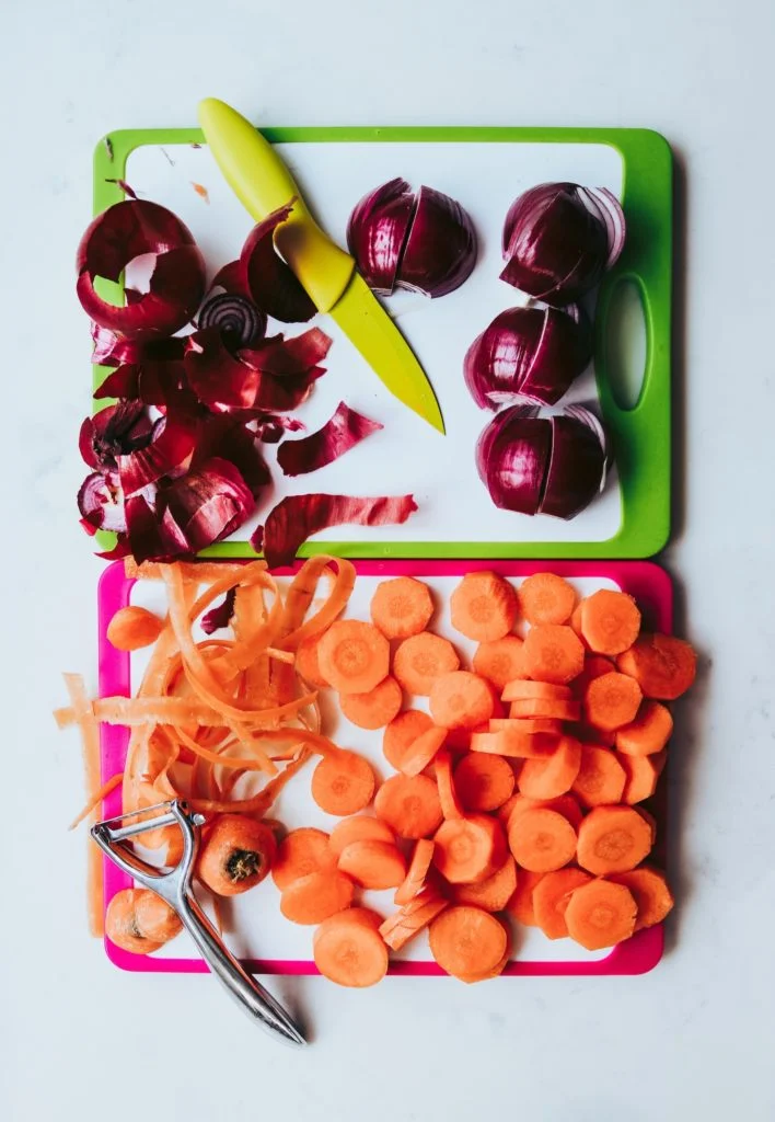 red onion and carrots on cutting boards