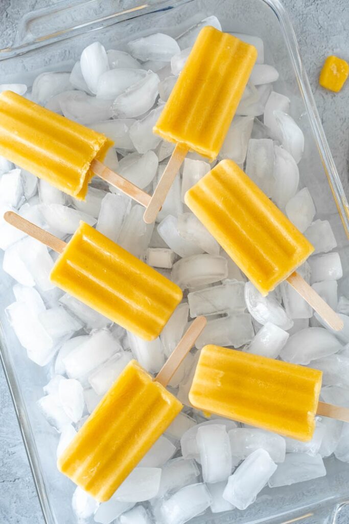 popsicles in tray filled with ice