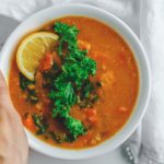 hand holding bowl of soup