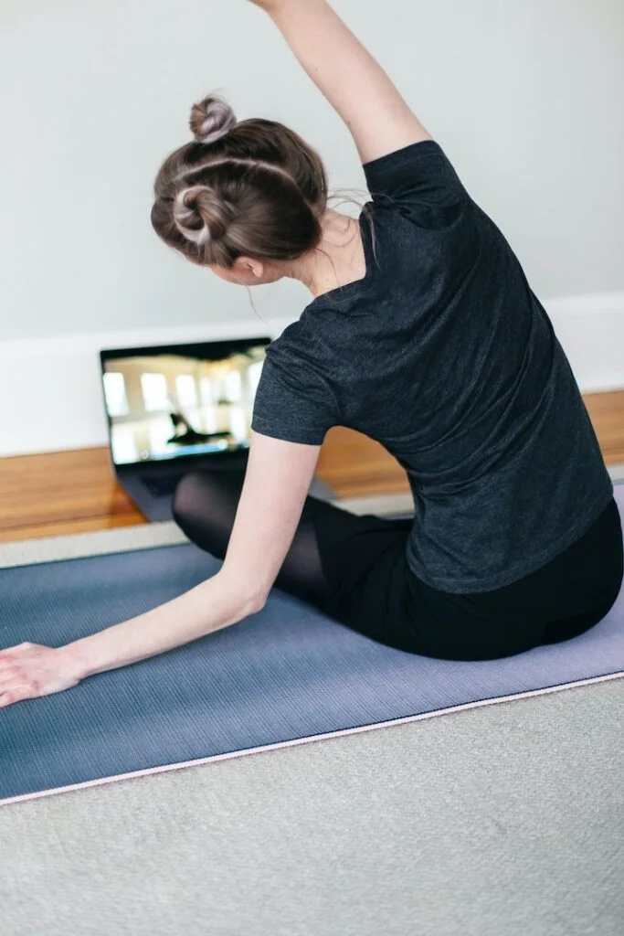 woman stretching on yoga mat