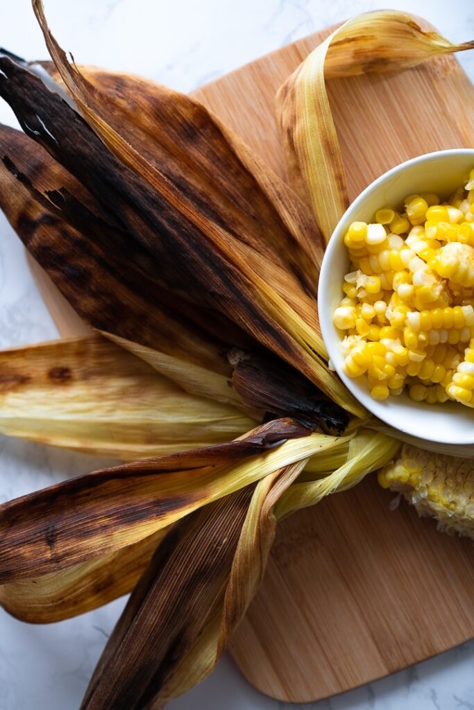 grilled corn husk and bowl of corn kernels