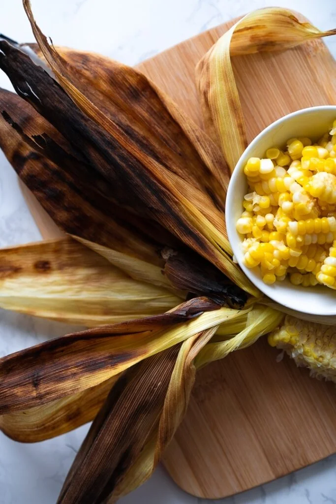 grilled corn husk and bowl of corn kernels