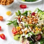 plaes with salad topped with chickpeas and vegetables