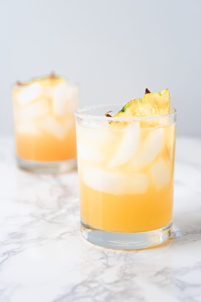 two glasses with pineapple juice and ice