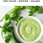 bowl of green sauce surrounded by fresh cilantro and lime slices