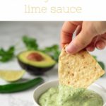 tortilla chip being dipped into green sauce
