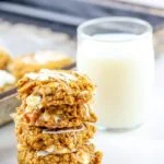 stack of pumpkin breakfast cookies with glass of milk in background