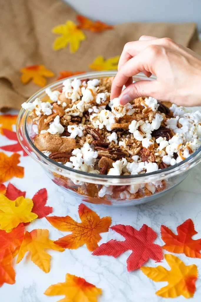 hand reaching into bowl of halloween trail mix