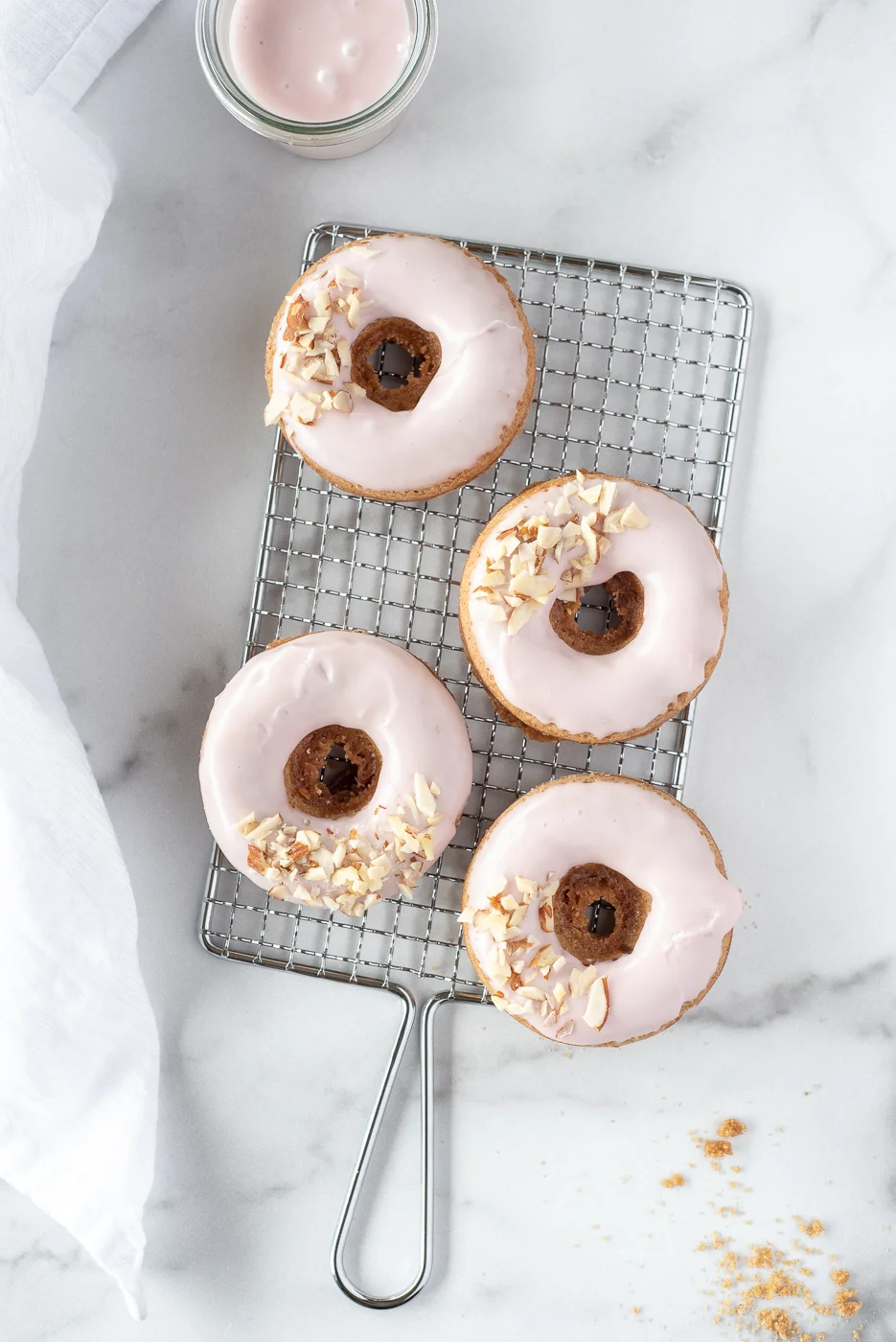 cooling rack with four pastel pink donuts