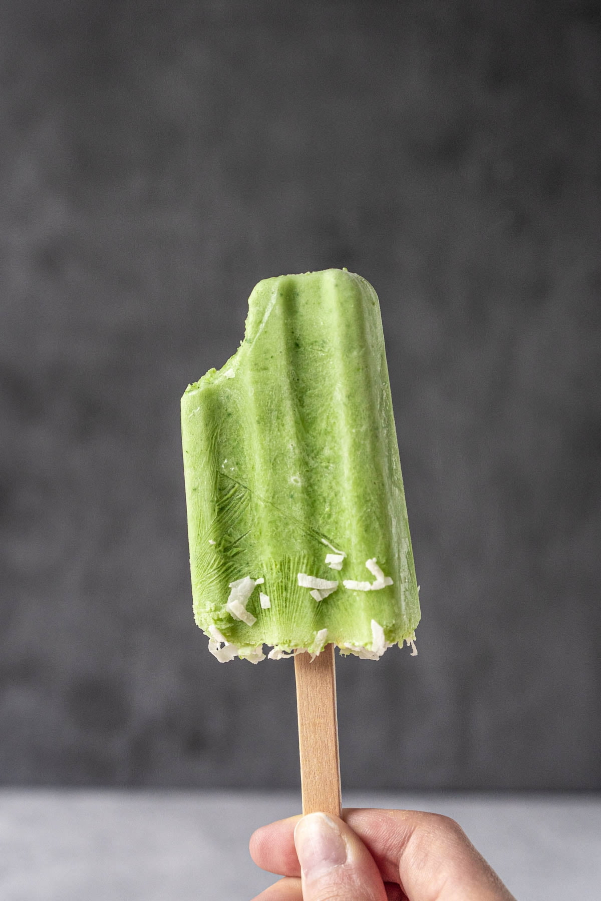 green popsicles with shredded coconut pieces