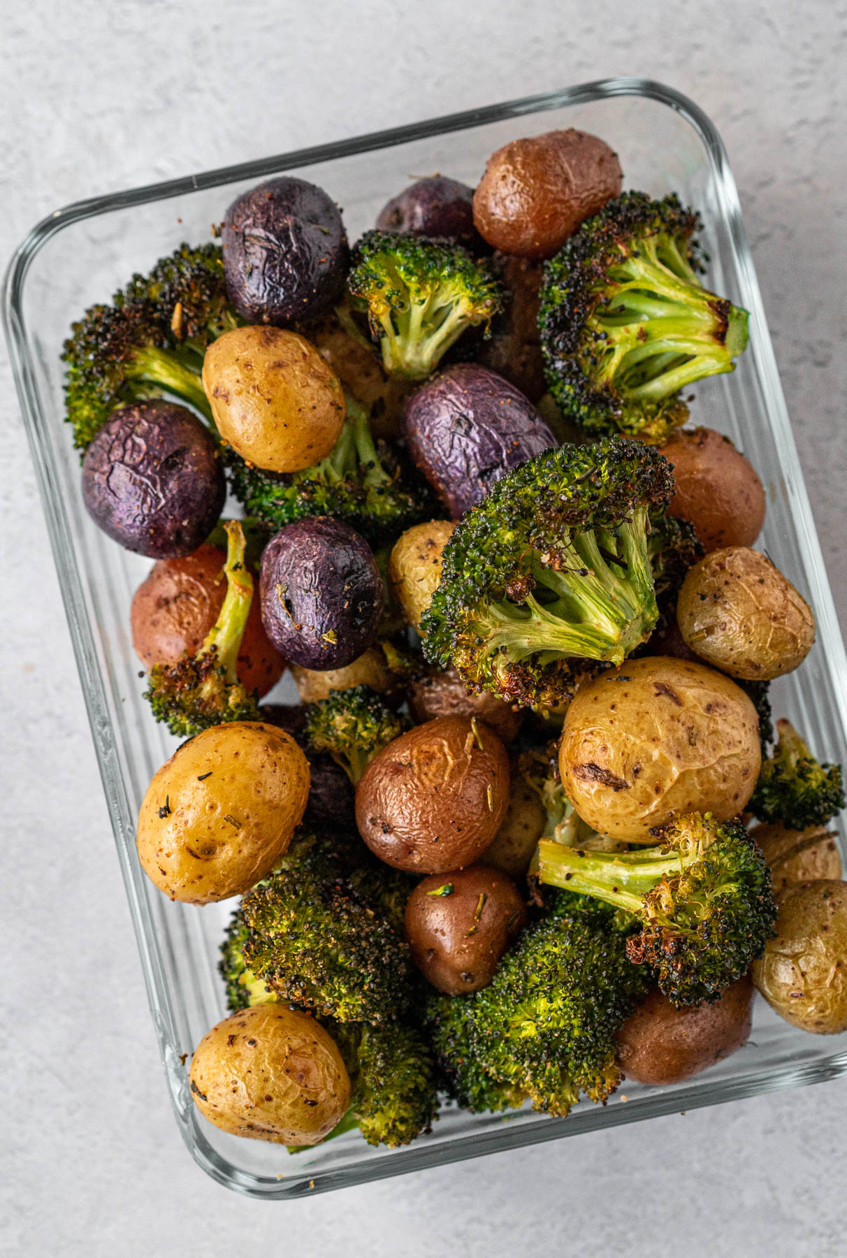 food storage container with roasted broccoli and potatoes