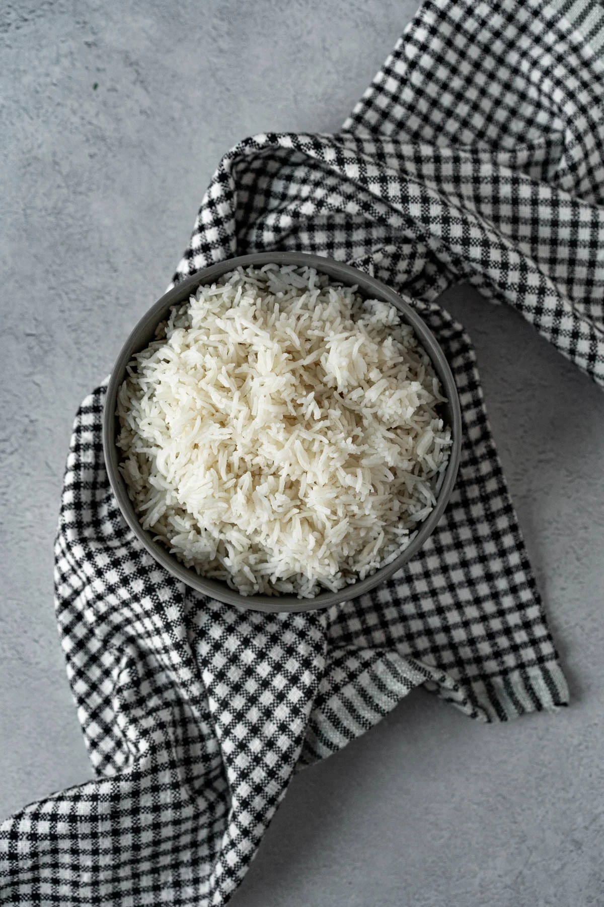 bowl of white rice on a checkered napkin