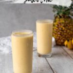 two glasses filled with a pale yellow smoothie