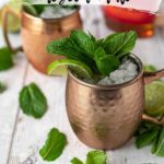 copper mugs filled with ice and garnished with lime and mint