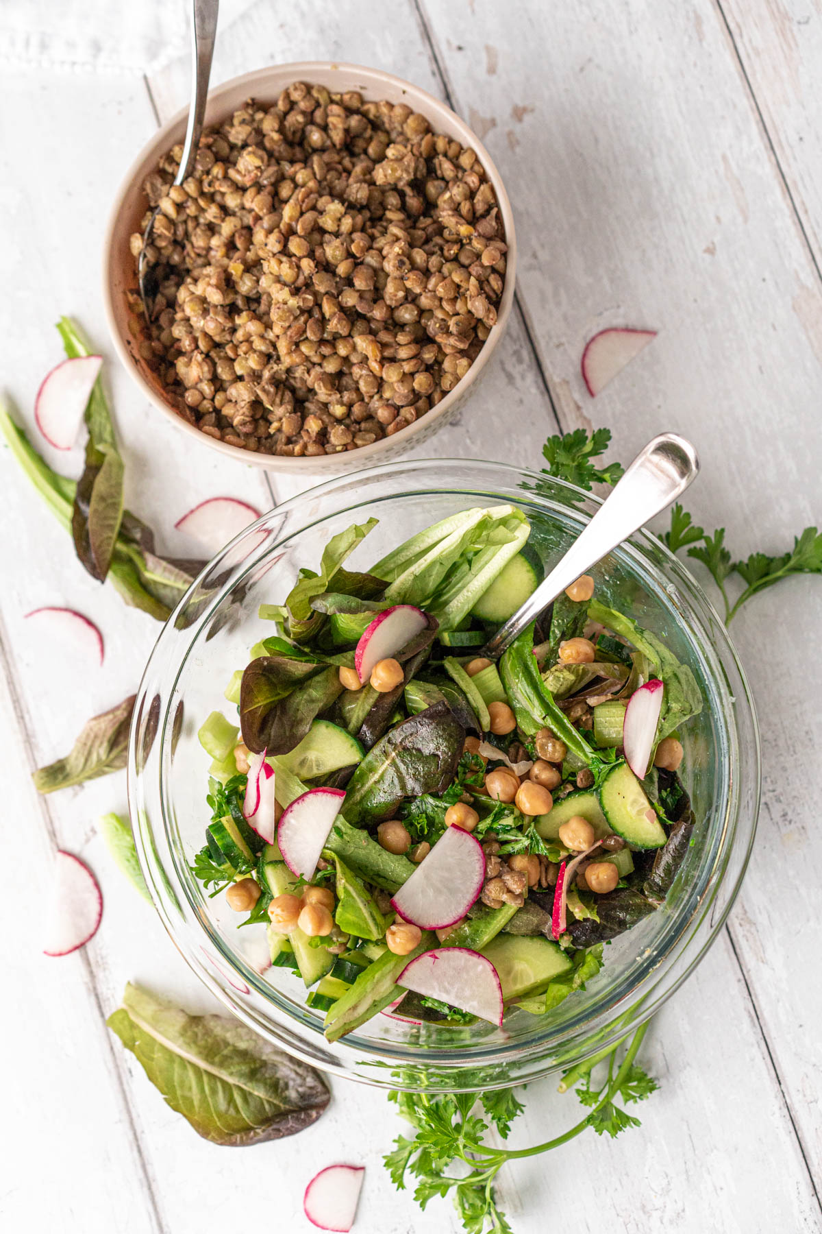 bowls of spring mixed green salad and lentils