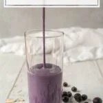 pouring smoothie into a glass
