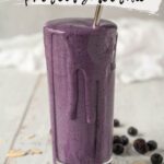 glass overflowing with purple protein shake