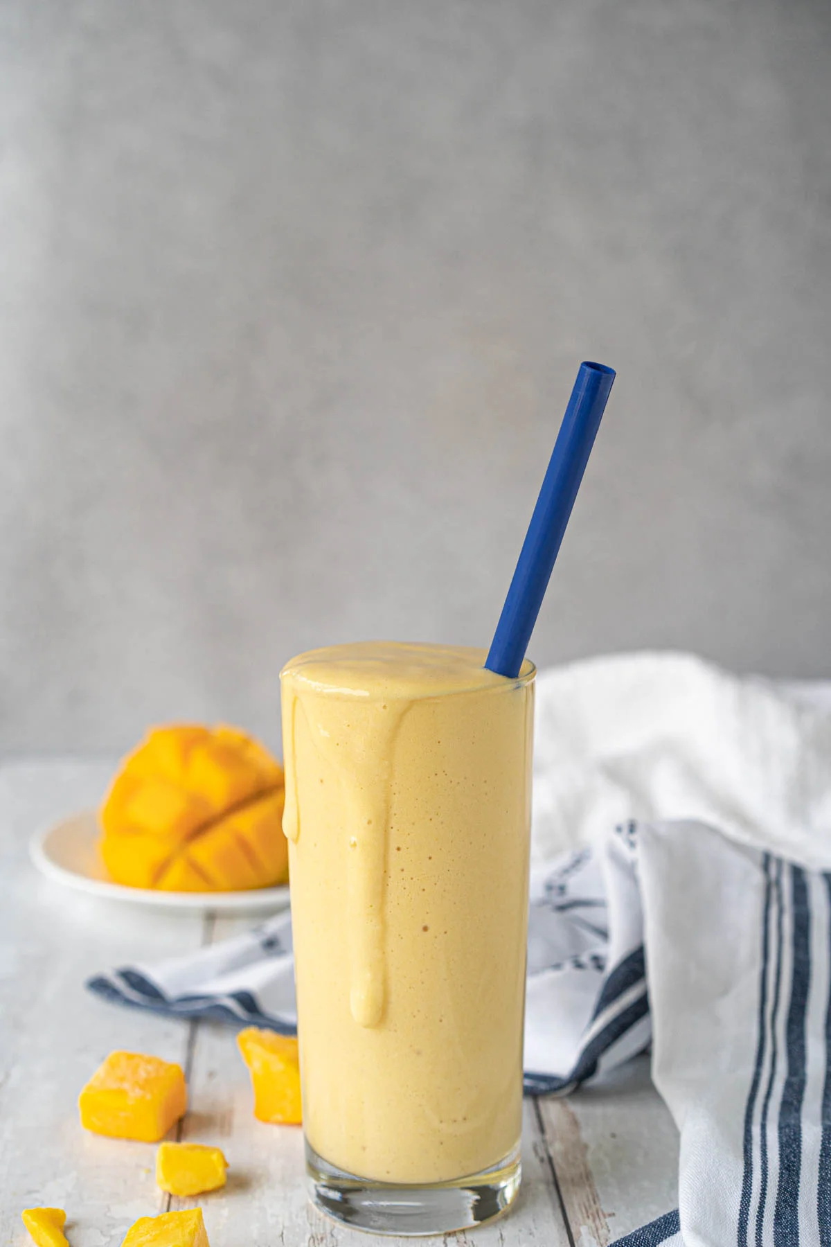 glass with a yellow shake and a blue straw