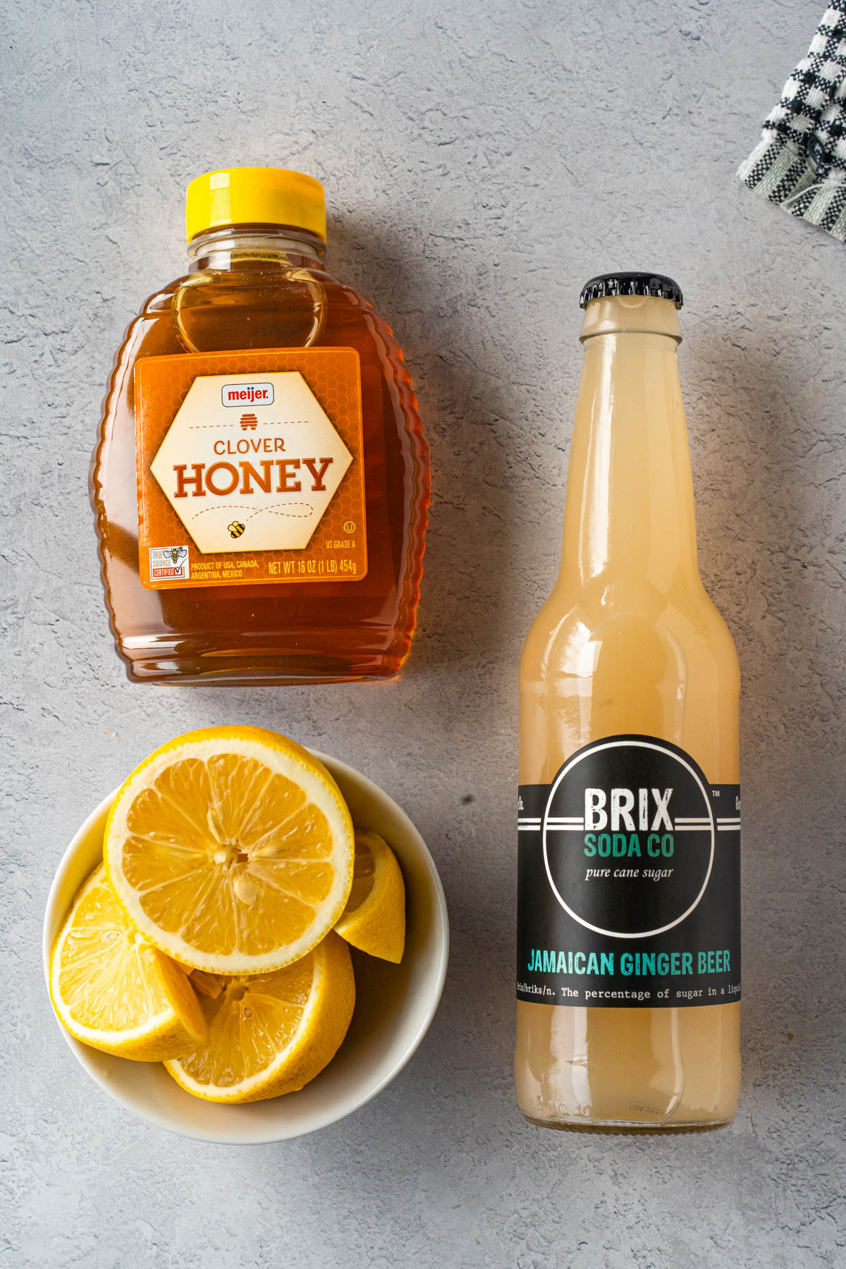 top-down view of ingredients, including honey, lemons, and ginger beer