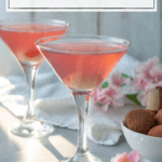 image of two martini glasses against a white background decorated with pale pink flowers and a bowl of lychee fruit; each glass is filled with a pale pink drink and garnished with a lychee; white text box at the top of the image reads 'lychee martini non-alcoholic + mocktail'